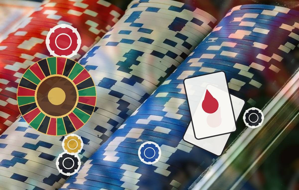 Colorful casino chips, a roulette wheel, and playing cards with a red drop symbol on a blurred gambling background.